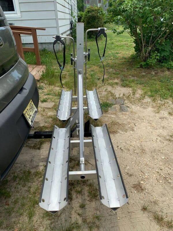 A bike rack attached to the back of a car.