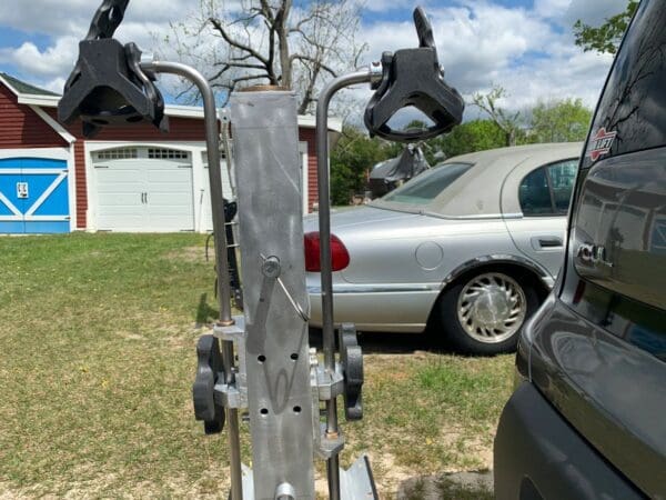 A silver car parked in front of a house.