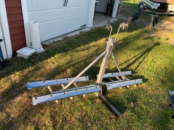 A bicycle rack in the grass near a garage.