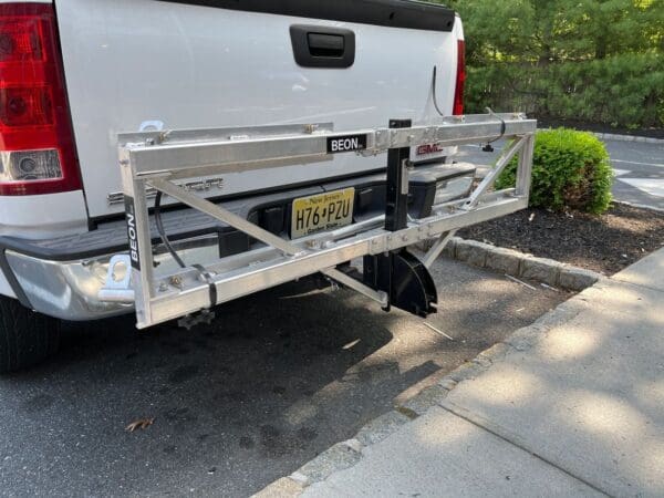 A truck with a ramp attached to it's back.