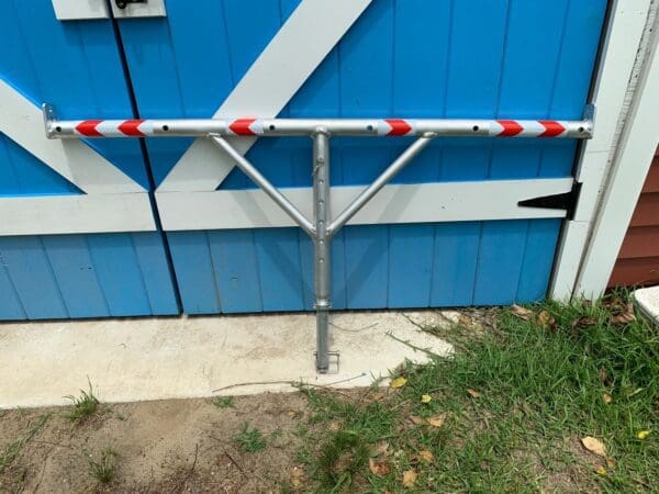 A metal pole with red and white tape on it.