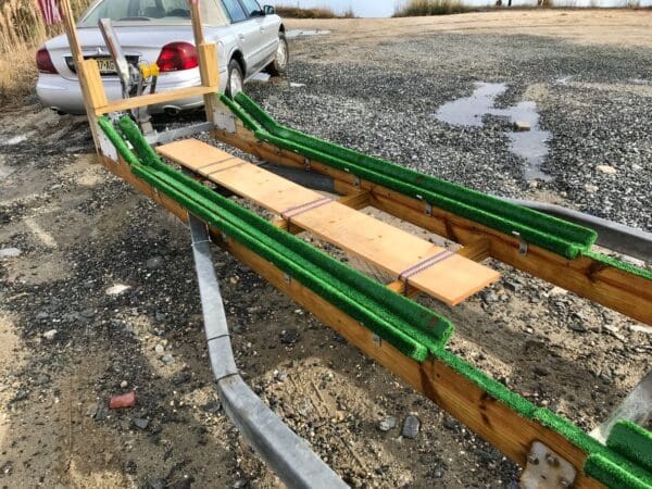 A truck with two green ramps on it