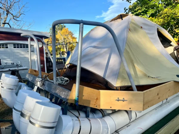 A boat with a tarp on top of it.