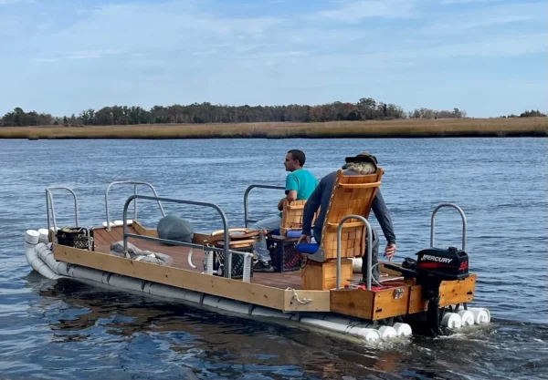 A man and woman on a boat in the water.