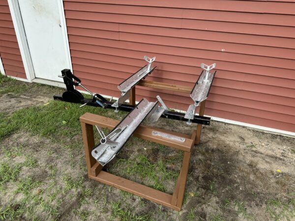 A pair of metal pipes sitting on top of a wooden stand.