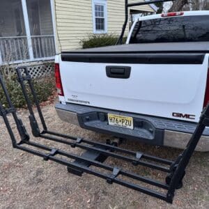 Black bike rack on white GMC truck.